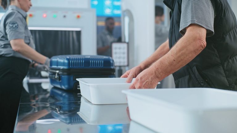Viral video divides passengers about handling TSA security bins or not after screening